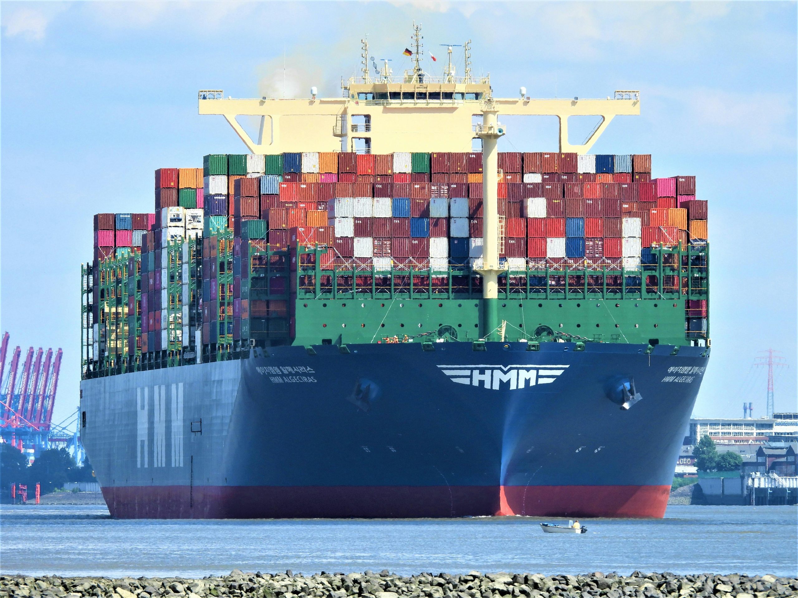 Ship sailing on high seas loaded with multiple cargo containers, symbolizing global trade supported by SBLC monetization.